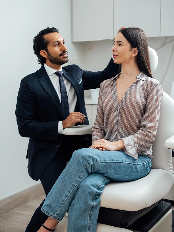 Dr Sameer Halani MD consulting with female patient during consulatation session in modern office - browlift in New York , NY